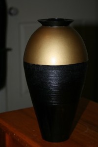 Vase. Turned from timber rescued from the wood heap. Features Egyptian style with pained top and scoured center added as a feature. Camphor 