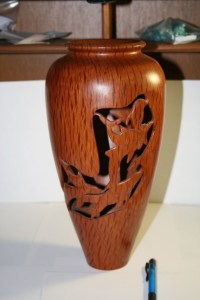 Vase. Has Dolphin carved features. Wall thickness 4mm to 5mm. Internal polishing to match external polishing. Turned from wet green timber. Sheoak.