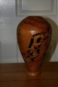 Vase with Dolphin features carved through the wall. Silky Oak.