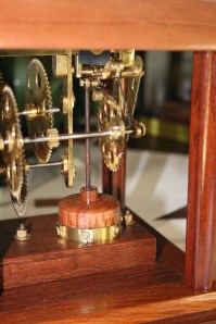 Side view of the movement. The coil has been covered by a wooden bell and the magnet pops up and down.
